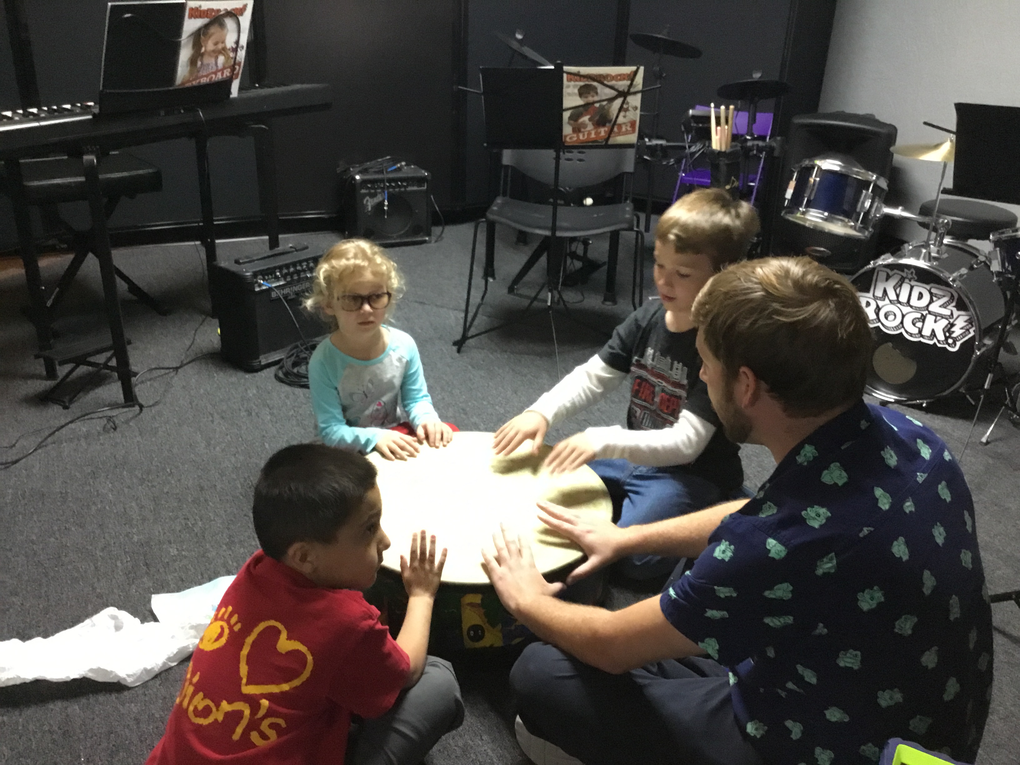 Students and teachers in a drum circle at Music on the Westside